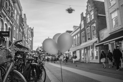 Bicycle by city against sky