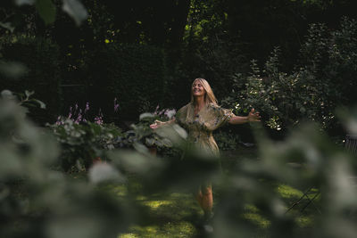 Smiling mature woman with eyes closed in garden