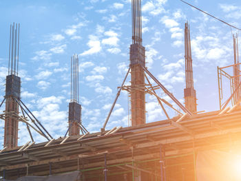 Low angle view of crane against sky