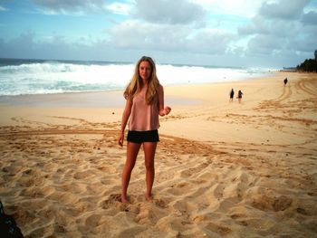 Young woman standing at beach