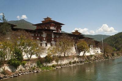 Building by river with mountain in background