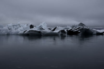 Scenic view of frozen lake against sky iceberg