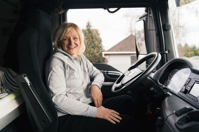 Portrait of woman sitting in car