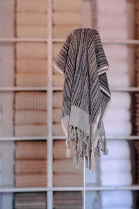 Close-up of white tied hanging on wood