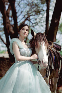 At sunset, a beautiful sensual girl and her horse go through the woods. horses are adored by girls.