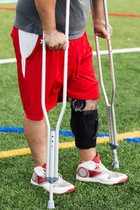 Low section of man standing on grass