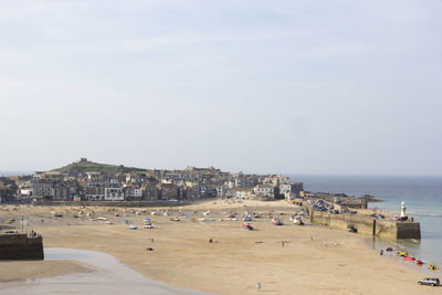 High angle view of houses by sea against sky at beach