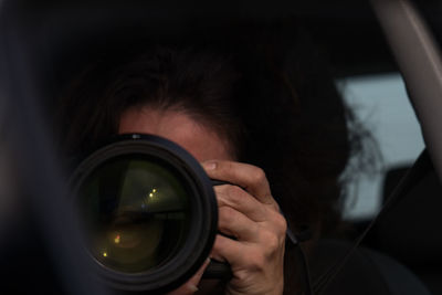 Close-up of woman photographing through camera
