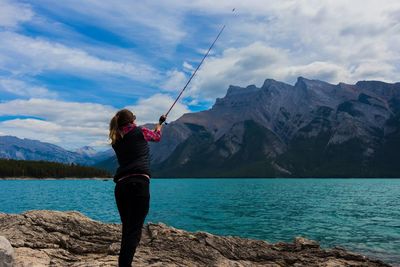 Rear view of man fishing at lake