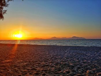 Scenic view of sea against clear sky during sunset