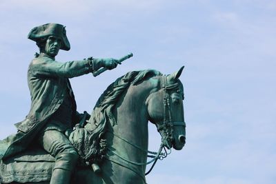 Low angle view of statue against sky