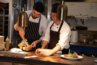 Midsection of man preparing food in restaurant