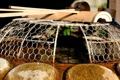 Close-up of water in container at shrine