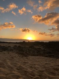 Scenic view of beach against sky during sunset