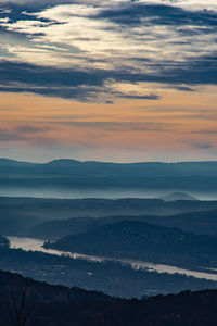 Scenic view of silhouette mountains against sky at sunset