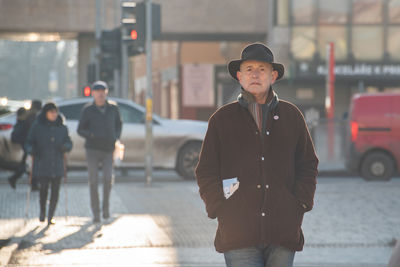 Young man walking on street in city