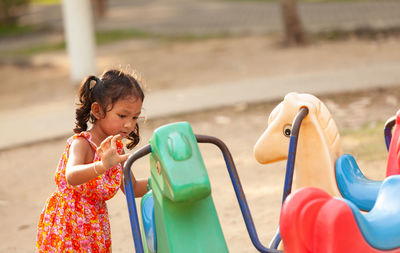 Rear view of girl playing in water