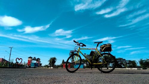 Low angle view of bicycle on road against sky