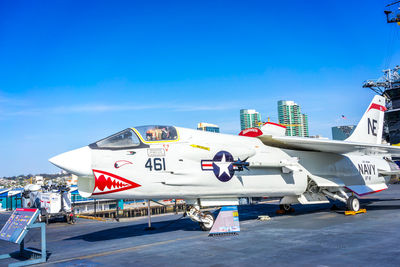 Airplane on airport runway against blue sky