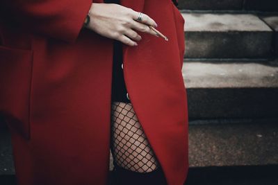 Low section of woman standing on red floor