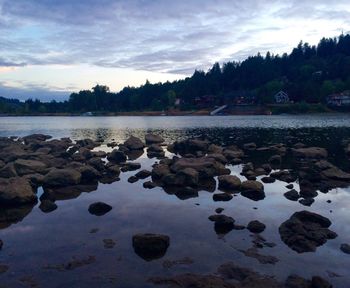 Scenic view of lake against cloudy sky