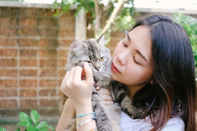 Close-up of woman with cat