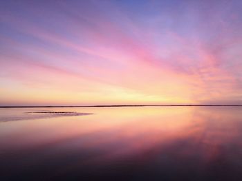 Scenic view of sea against romantic sky at sunset