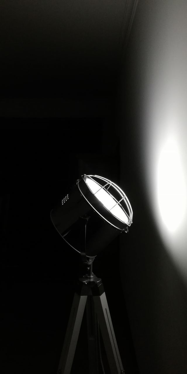 LOW ANGLE VIEW OF ILLUMINATED LAMP AGAINST DARK SKY