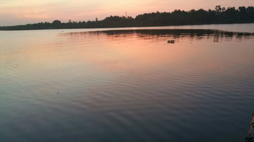 Scenic view of lake at sunset