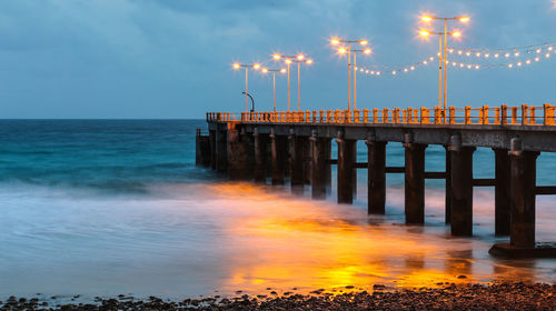 Pier over sea against sky