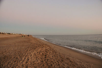 Scenic view of beach against sky during sunset