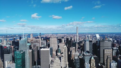 Aerial view of city against cloudy sky