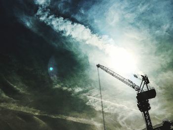 Low angle view of cranes at construction site