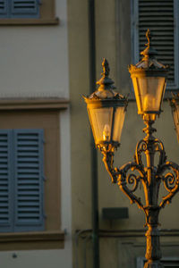 Close-up of illuminated lamp in city