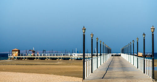 Scenic view of beach against clear blue sky