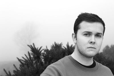 Portrait of young man against sky