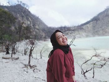 Young woman standing on land during winter