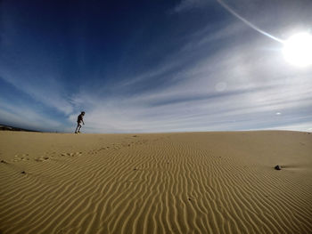 Man on sand at beach against sky