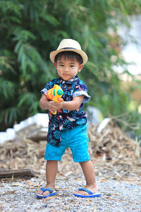 Cute boy playing with water gun