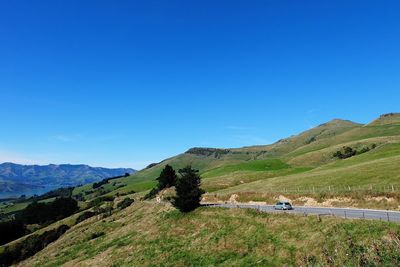 Scenic view of mountains against clear blue sky