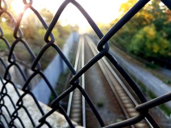 Close-up of chainlink fence against sky