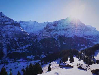 Scenic view of snowcapped mountains against blue sky