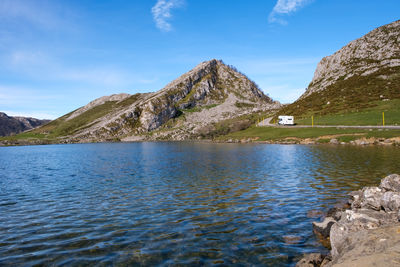 Scenic view of lake and mountains against sky