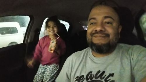 Portrait of a smiling young woman in car