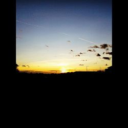Silhouette of landscape against sky at sunset