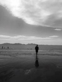Scenic view of sea against cloudy sky