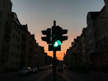 Traffic on road at sunset