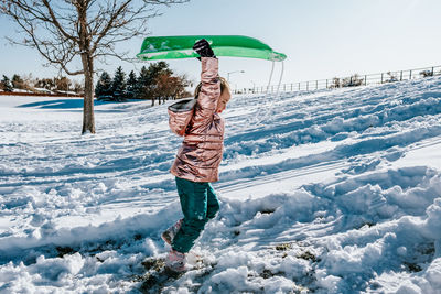 Man standing on snow covered field