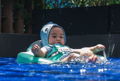 Portrait of boy swimming in pool