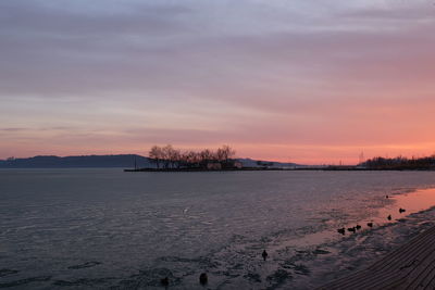 Scenic view of lake against sky during sunset